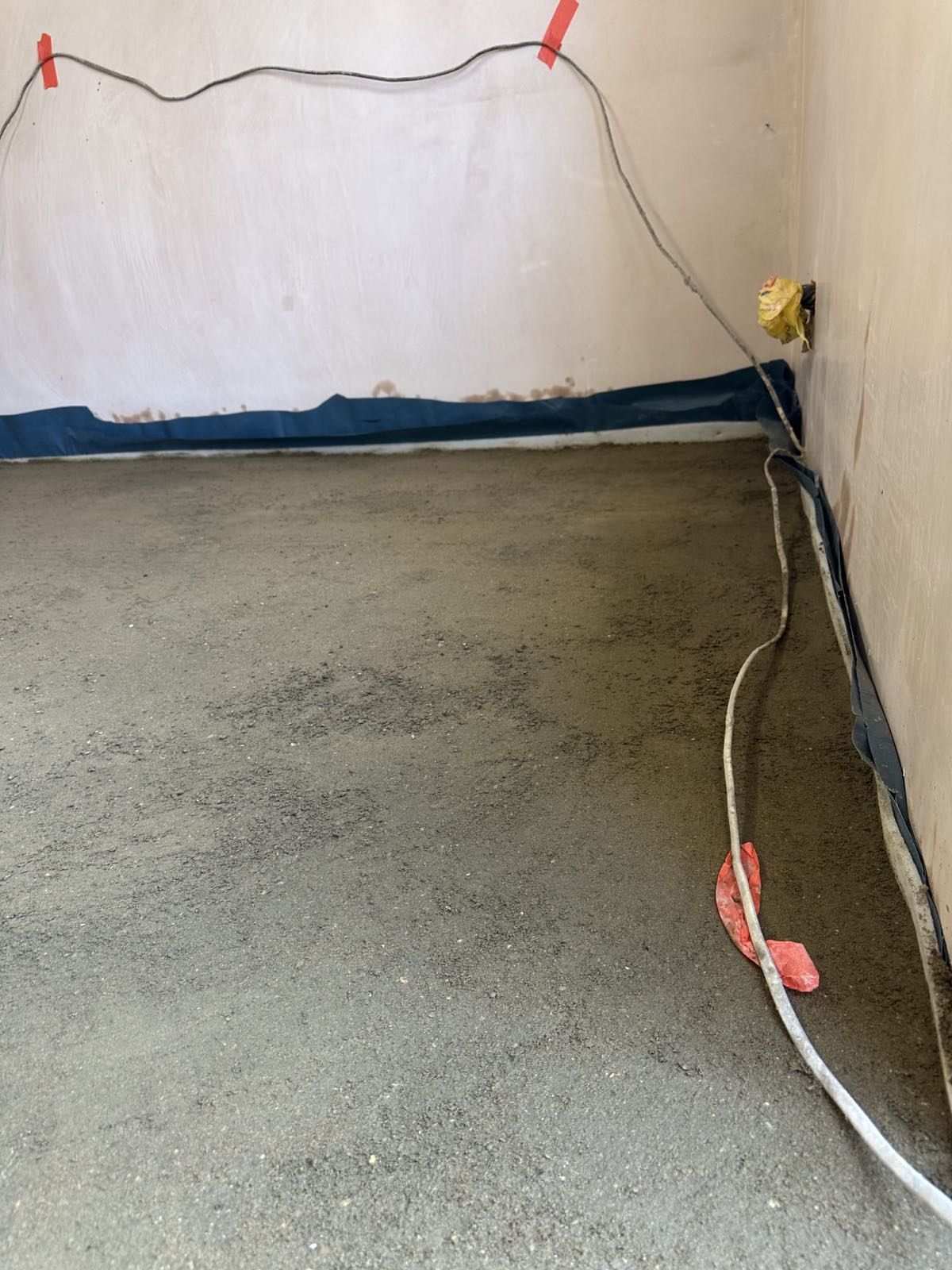 Finished garage conversion floor showing perimeter edge strip detail