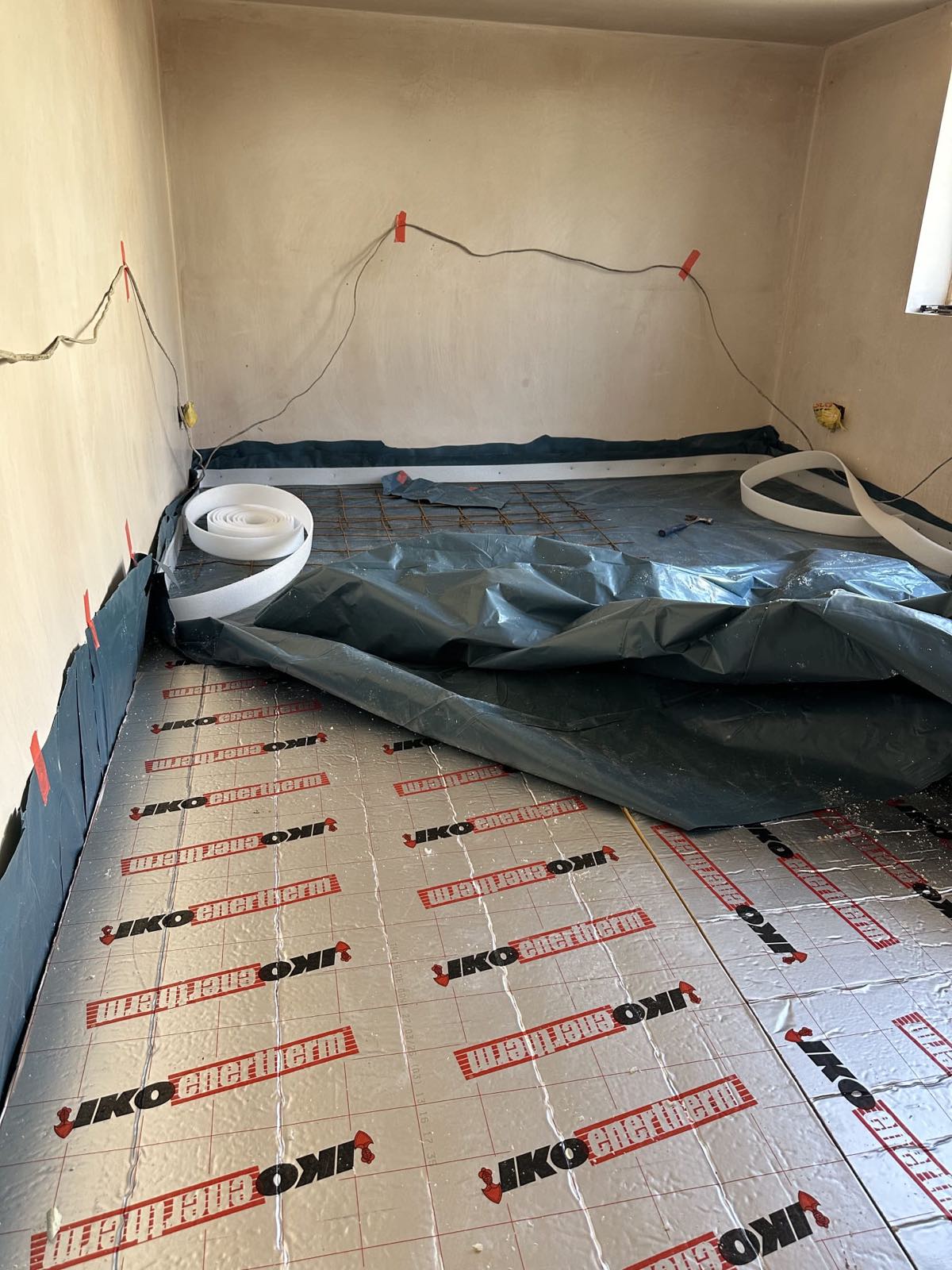 PIR insulation boards laid tight over a damp proof membrane in a garage conversion