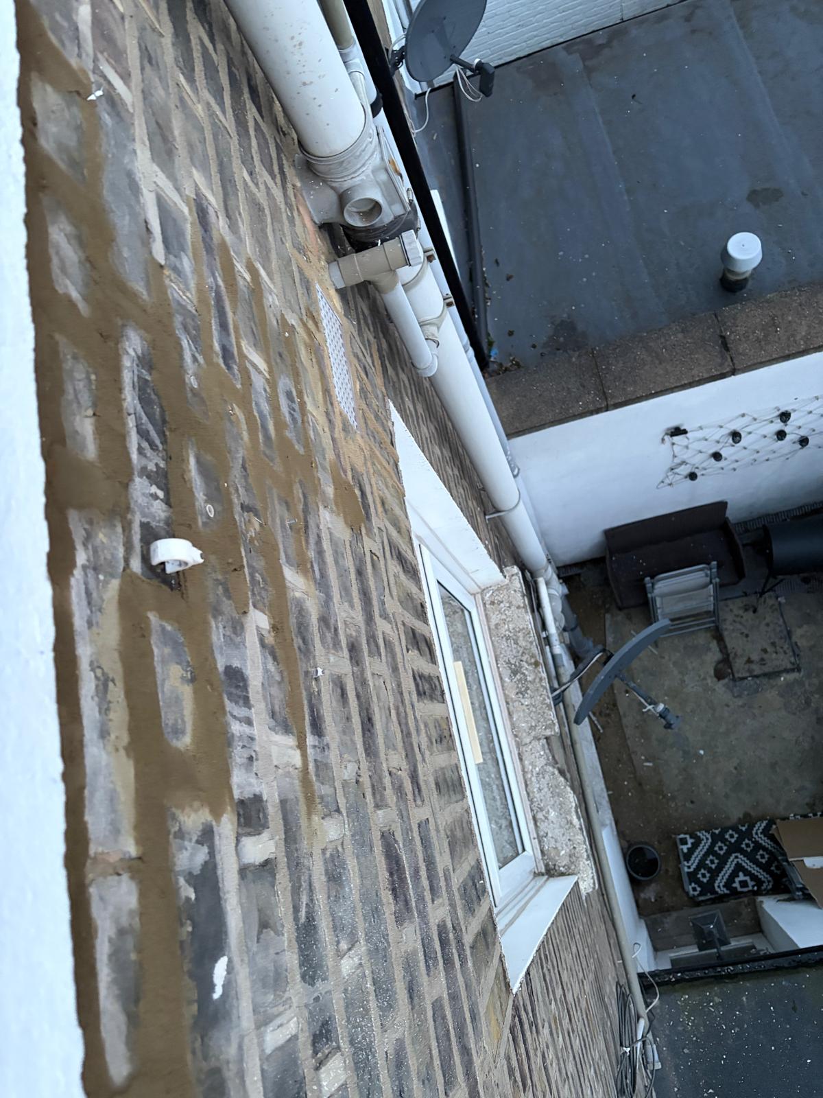 brick wall pointing repair under window in N8 London